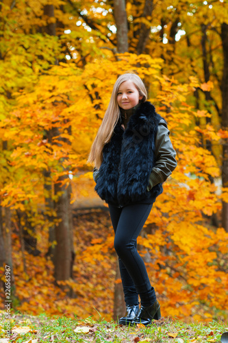 attractive young girl walking in autumn park © Ruslan Solntsev