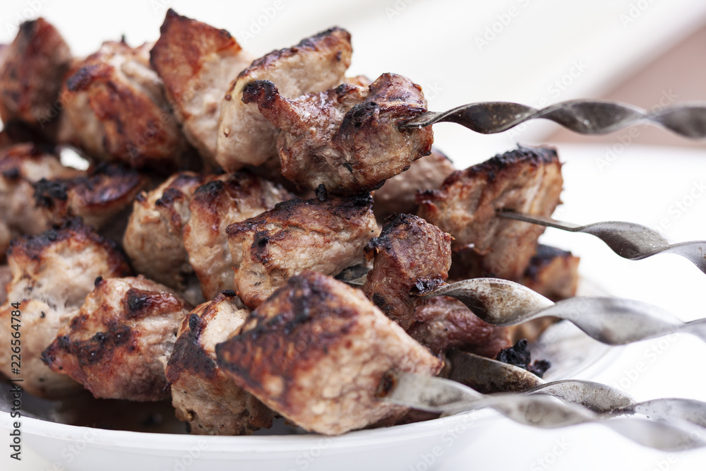 Barbecue meat, grilled pork skewers, shashlik kebab on plate