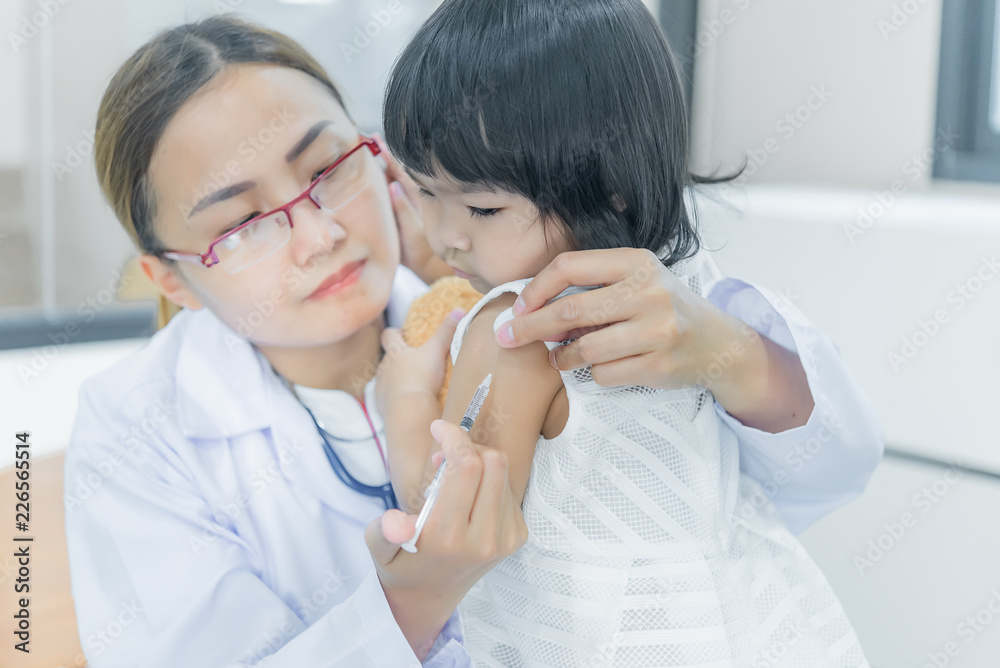Asian doctor using a stethoscope to check his breathing and heart of a lovely girl, check the health of children,Thailand people Asian doctor using a stethoscope to check his breathing and heart of a lovely girl, check the health of children,Thailand people
