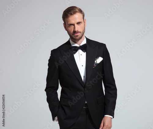 Photography portrait of a young goom wearing tuxedo and bowtie