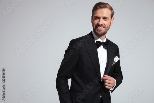 happy young elegant man smiles and looks to side