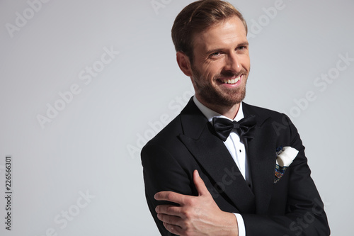 closeup portrait of a laughing elegant man wearing tuxedo
