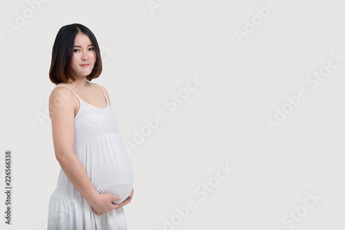 Portrait of asian pregnant woman on white background,thailand people use hand touch belly