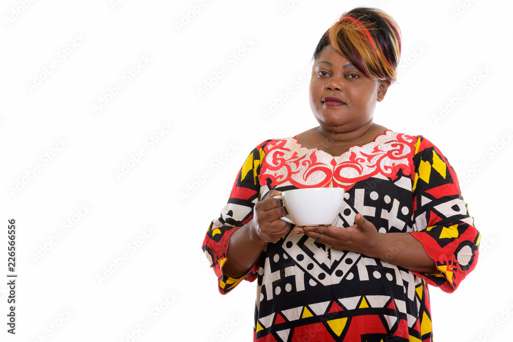 Studio shot of fat black African woman holding coffee cup Studio shot of fat black African woman holding coffee cup
