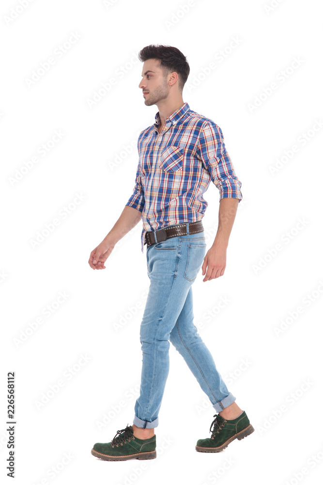 man wearing a shirt with red checkers walks to side man wearing a shirt with red checkers walks to side