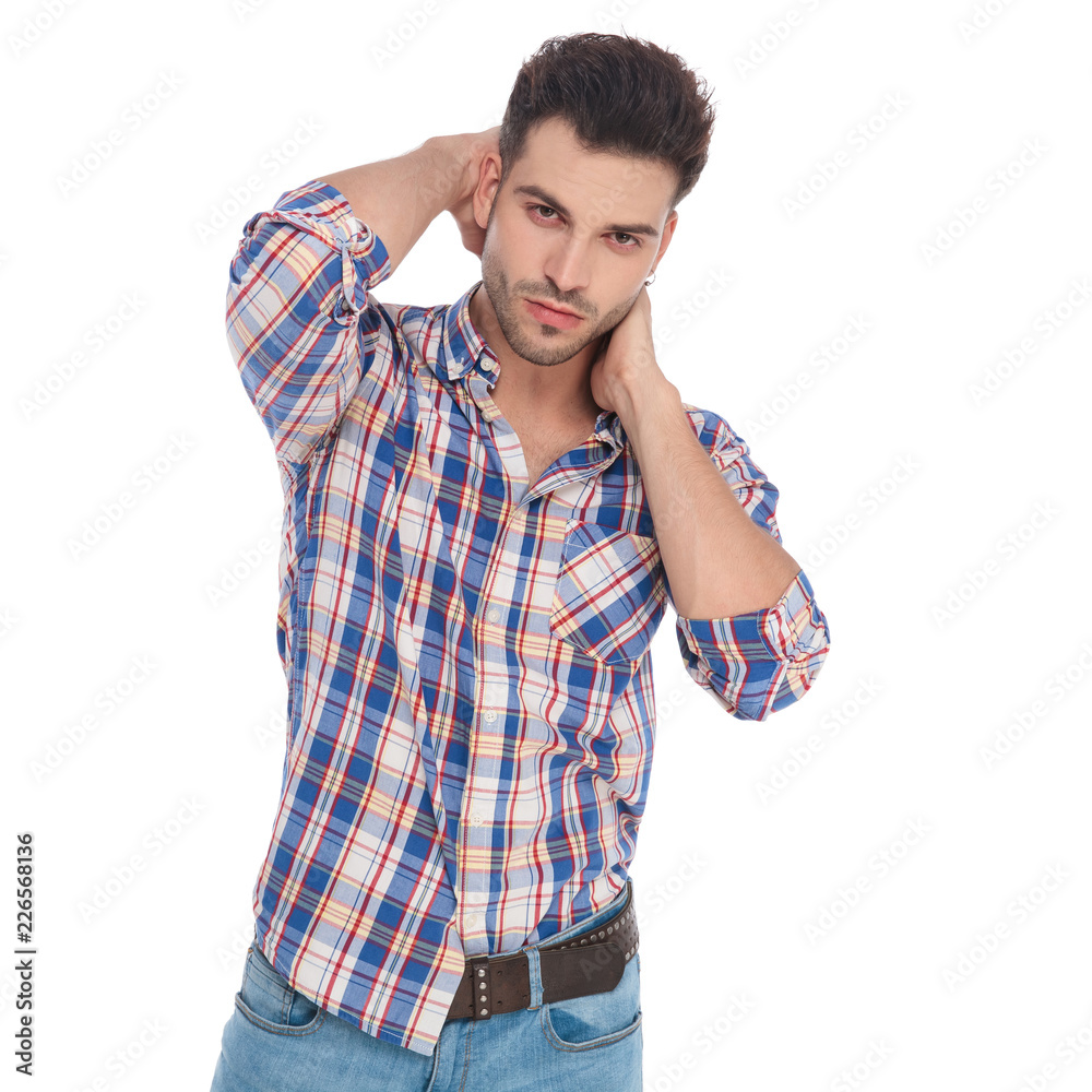 portrait of young man holding his neck in sensual pose portrait of young man holding his neck in sensual pose