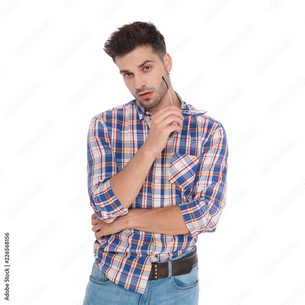 portrait of seductive casual man holding sunglasses and portrait of seductive casual man holding sunglasses and