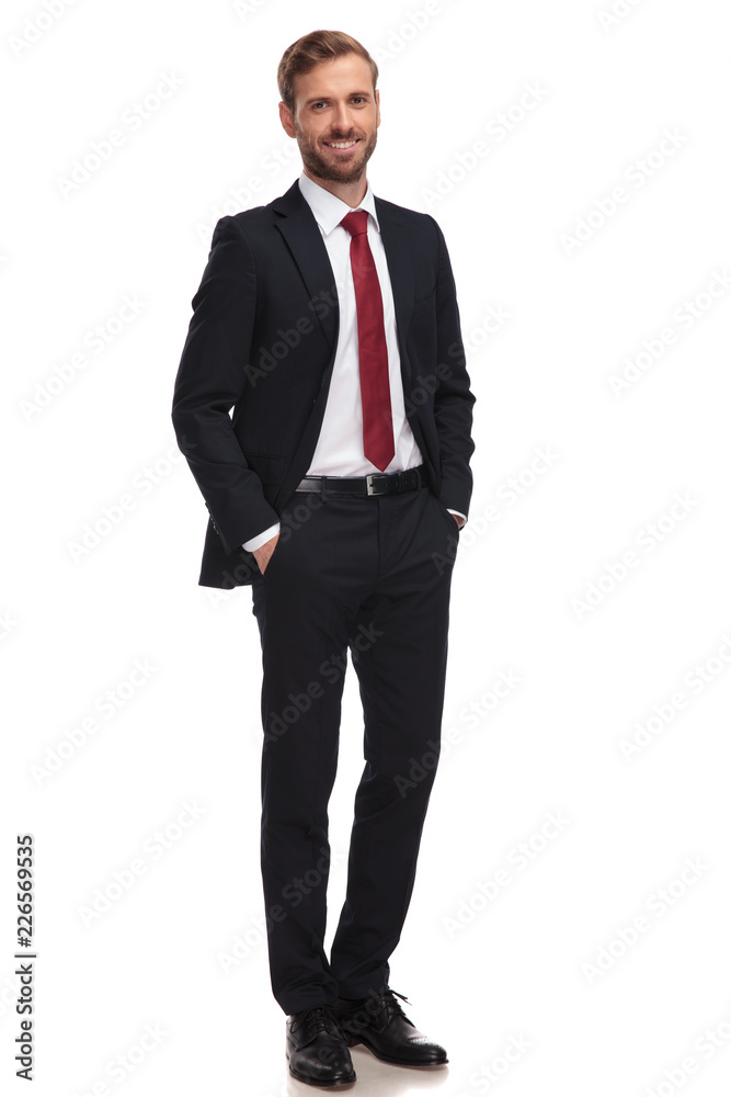 relaxed businessman smiling and standing with hands in pockets relaxed businessman smiling and standing with hands in pockets