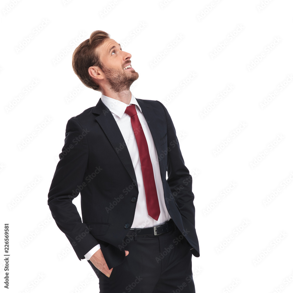 portrait of relaxed and joyful businessman looking up to side