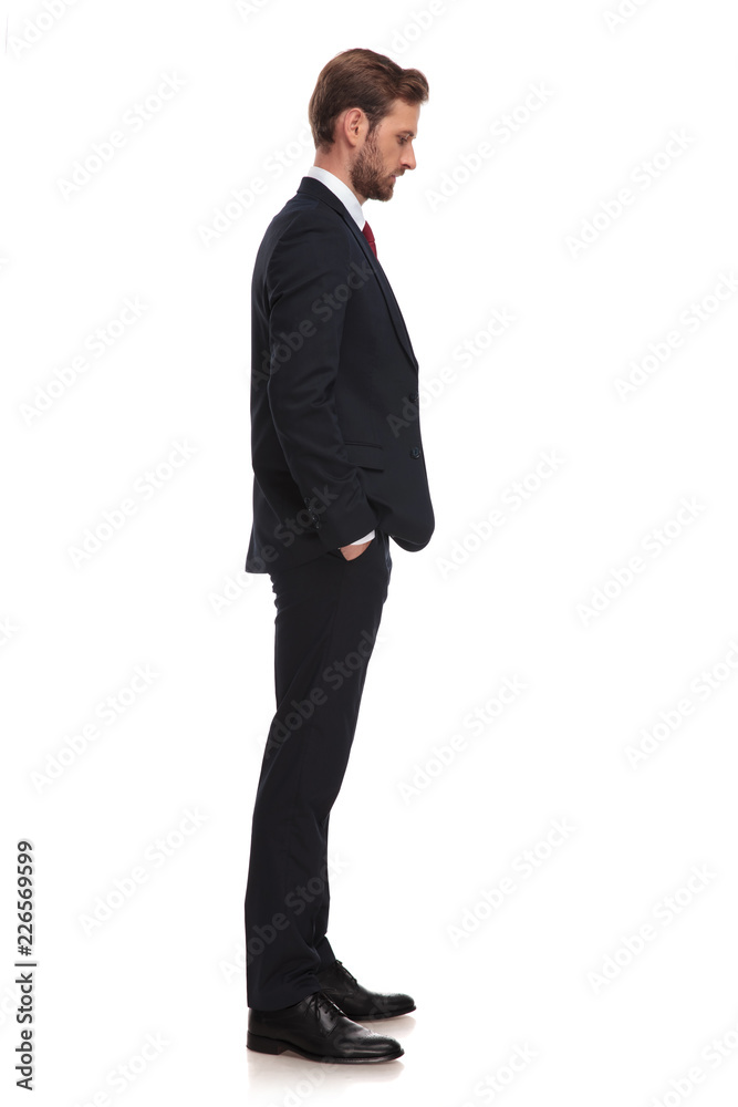 businessman waiting in line and looking down at something businessman waiting in line and looking down at something