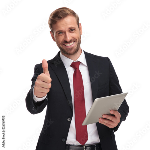 Φωτογραφία portrait of smiling businessman holding tablet and making ok sign