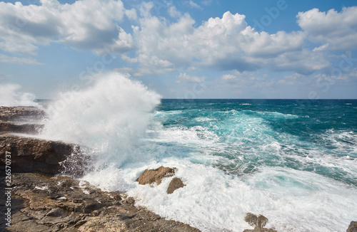 Big waves break about the Rocky Peninsula of Cape Lara in southern Akamas