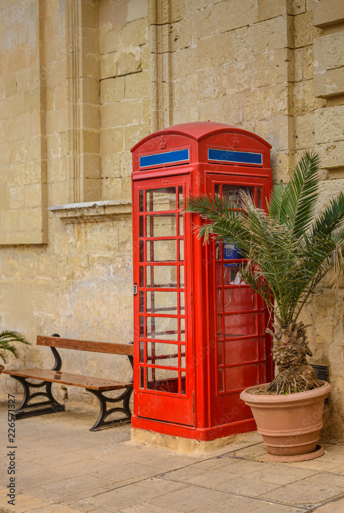Obraz premium Red vintage telephone booth. Public telephone.English style.