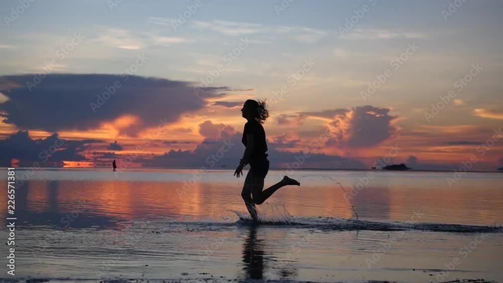 Sportswoman runs along the coast on the water against the backdrop of the sunset. HD, 1920x1080, slow motion Sportswoman runs along the coast on the water against the backdrop of the sunset. HD, 1920x1080, slow motion