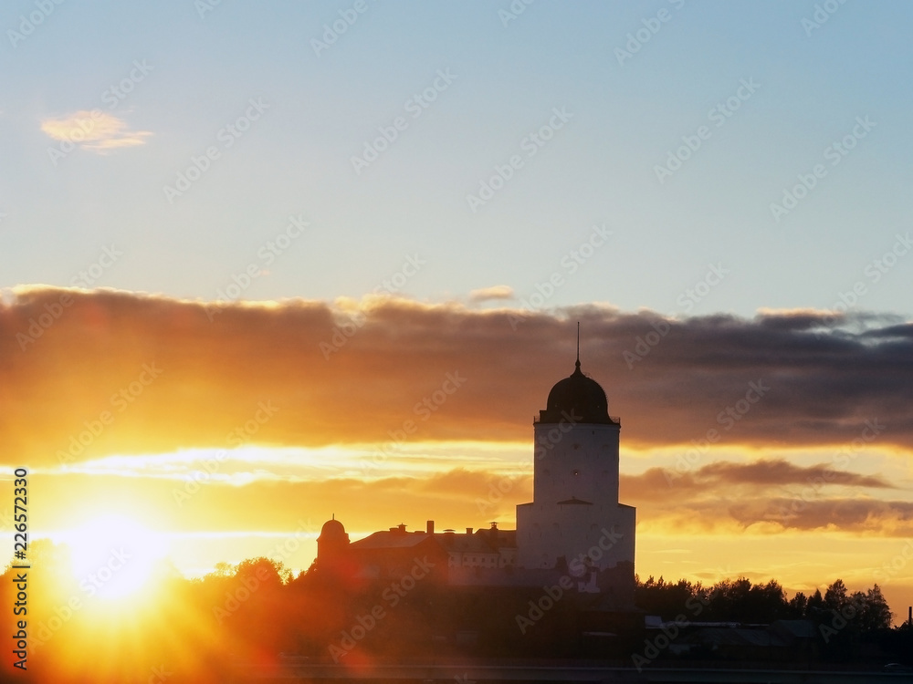 Saint Olav tower, medieval Swedish fortress castle on the sunset background in Vyborg, Russia. Rays of the autumn sunset sun, sun glare