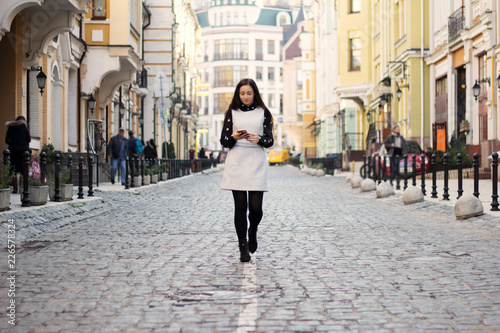 fashion happy woman walking smart phone on city street © natalysavina