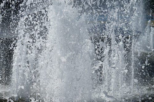 Splashes of fountain water in a sunny day.