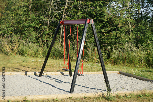 Empty swings on playground.
