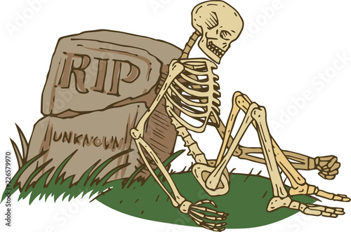 Skeleton Sitting Beside Old Gravestone