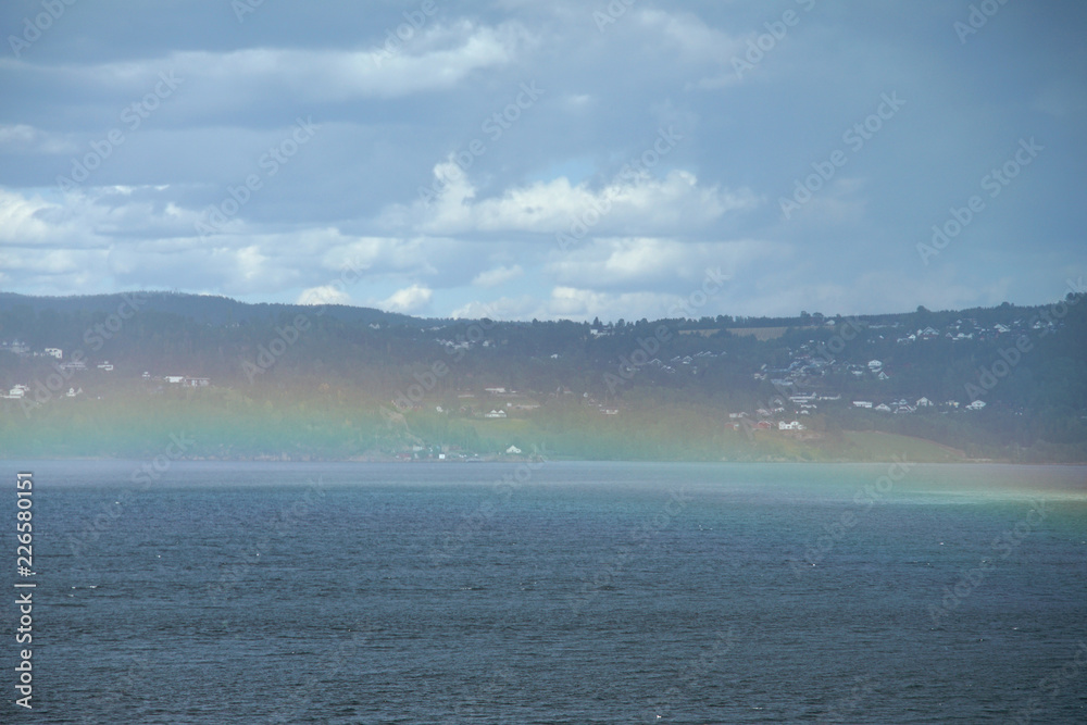 Rainbow over a fjord.