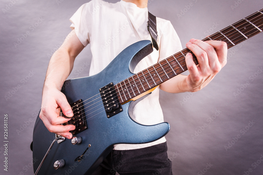 Fototapeta premium Close up of man playing on electric guitar