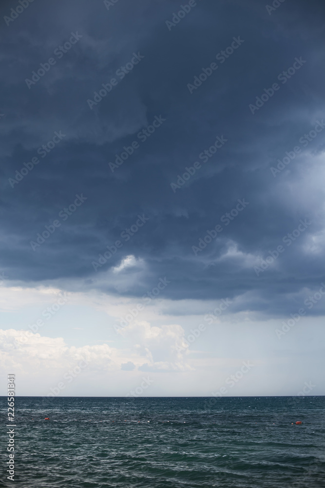 bad weather, a storm begins on the sea, dark blue clouds hang in the sky bad weather, a storm begins on the sea, dark blue clouds hang in the sky