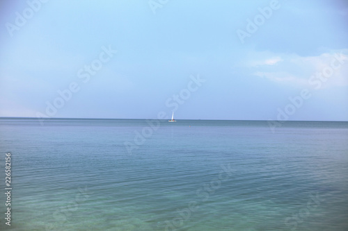 beautiful, calm, clean sea. a white ship sails on the sea