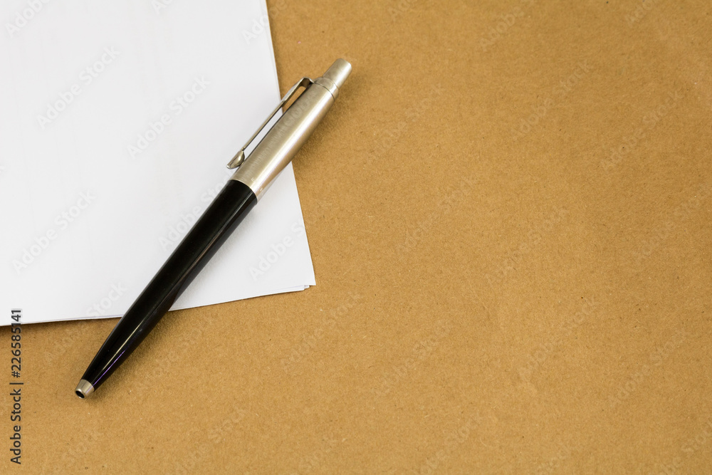 Pen and paper. Brown envelope background. Pen and paper. Brown envelope background.