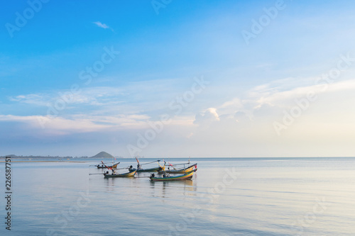 Fototapeta Naklejka Na Ścianę i Meble -  Five traditional Thai boats long tail in the sea at sunrise