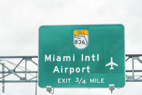 Road street highway green sign for Miami International Airport in Florida with exit in a mile, 836 toll turnpike text