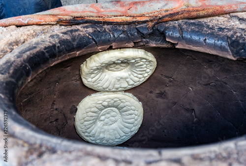 Traditional Uzbek flatbread baking in the tandyr