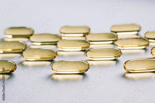 Fish oil capsules on gray background