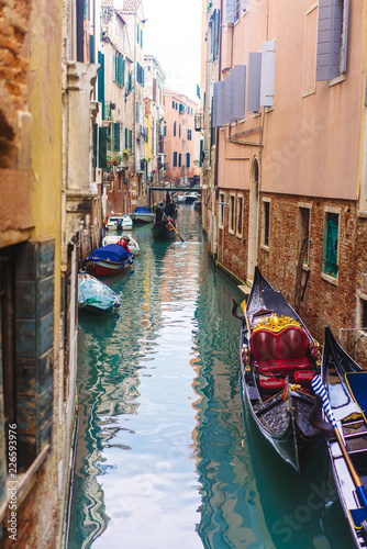 Venetian channel with ancient houses and boats © teksomolika