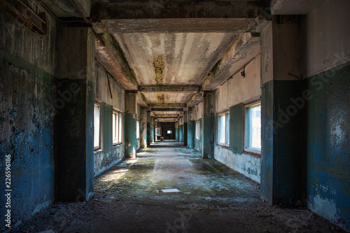 Creepy grunge tunnel or corridor in old ruined building. Way to freedom and hope concept