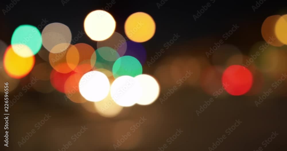 Out of focus cars pulling in front of distant bokeh from traffic lights for green screen or chroma key. Out of focus or defocused shot for compositing or keying. 