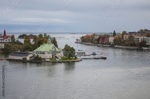 Houses among autumn trees on islands in the Baltic sea. Northern architecture, secluded life.