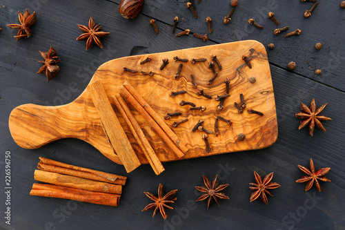 Christmas spices on wooden background