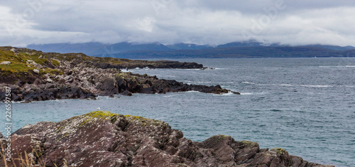 rocky shoreline of the ocean and bay facing the Dingle Peninsula across the water while driving along the Ring of Kerry