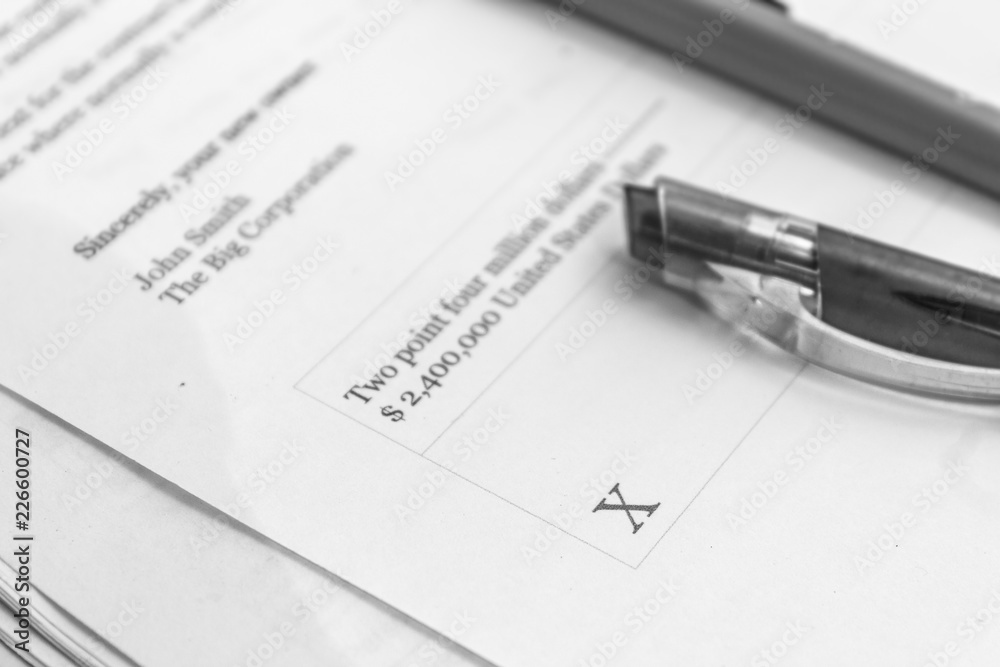 Black and white automotive insurance contract with pen. Sign and save on special offers. Black and white automotive insurance contract with pen. Sign and save on special offers.