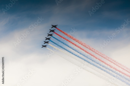 Russia. Saint-Petersburg. Kronshtadt. SU-25 combat aircraft fly during the parade with The Russian flag during the celebration of the Navy Day. 