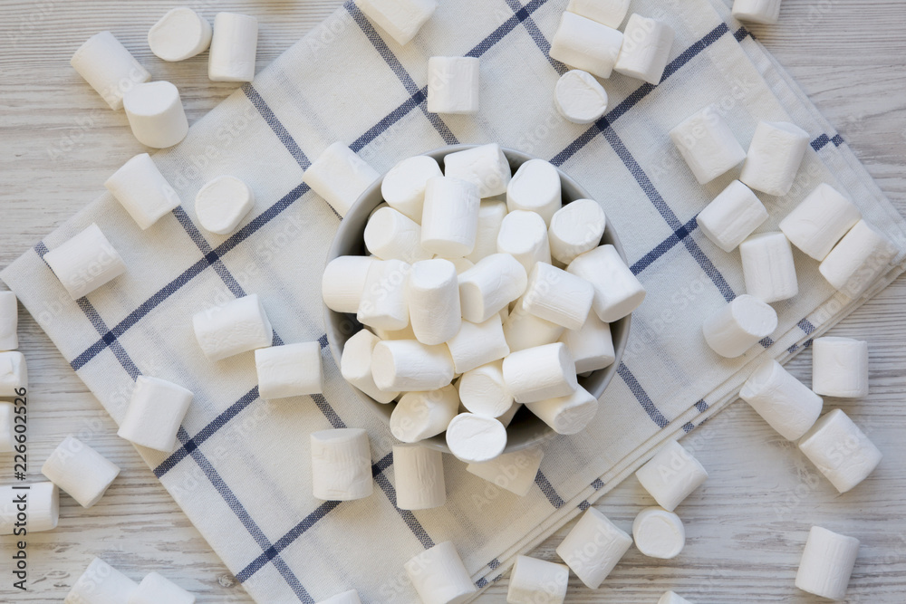 Sweet marshmallows in a bowl, overhead view. Flat lay, from above, top view. Closeup.