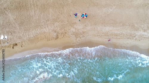 Aerial view of alone colorful umbrella on the beach. Holiday concept top view.