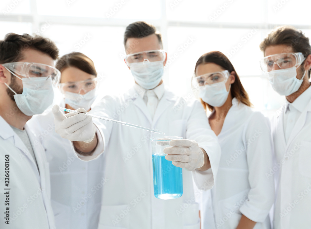 closeup of a group of medical workers working with liquids closeup of a group of medical workers working with liquids