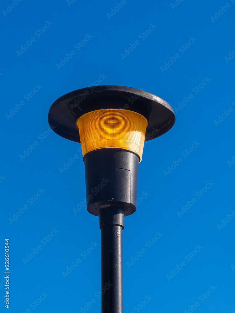 lit street light in daylight lit street light in daylight