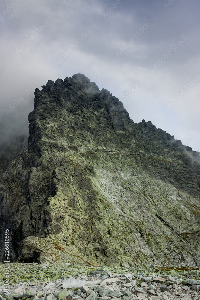 Rocky mountain summit between clouds