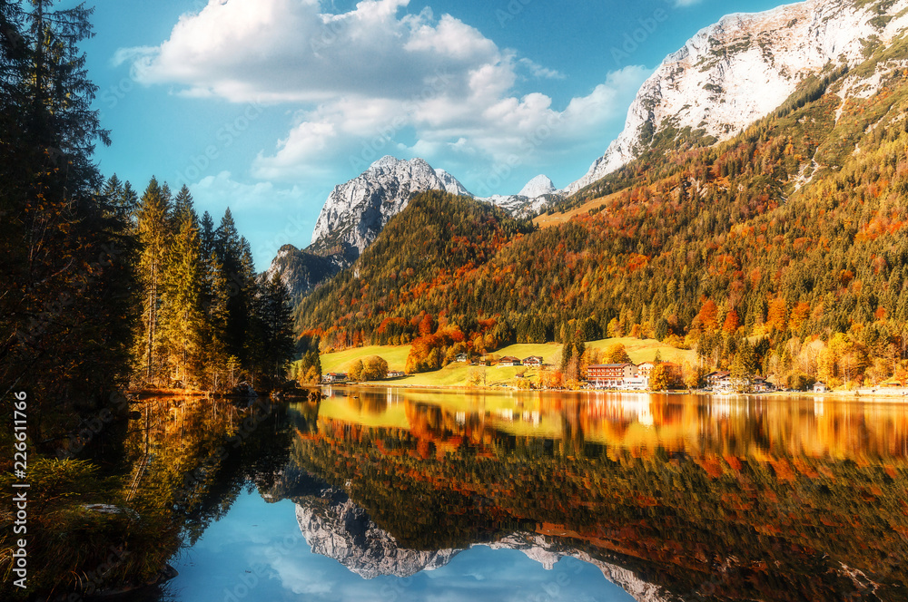 Beautiful Sunny Autumn mountain landscape at the Lake Hintersee, Ramsau, Bavaria, Germany. Amazing Picturesque Scene. A magnificent panorama of the mountains. Creative image.