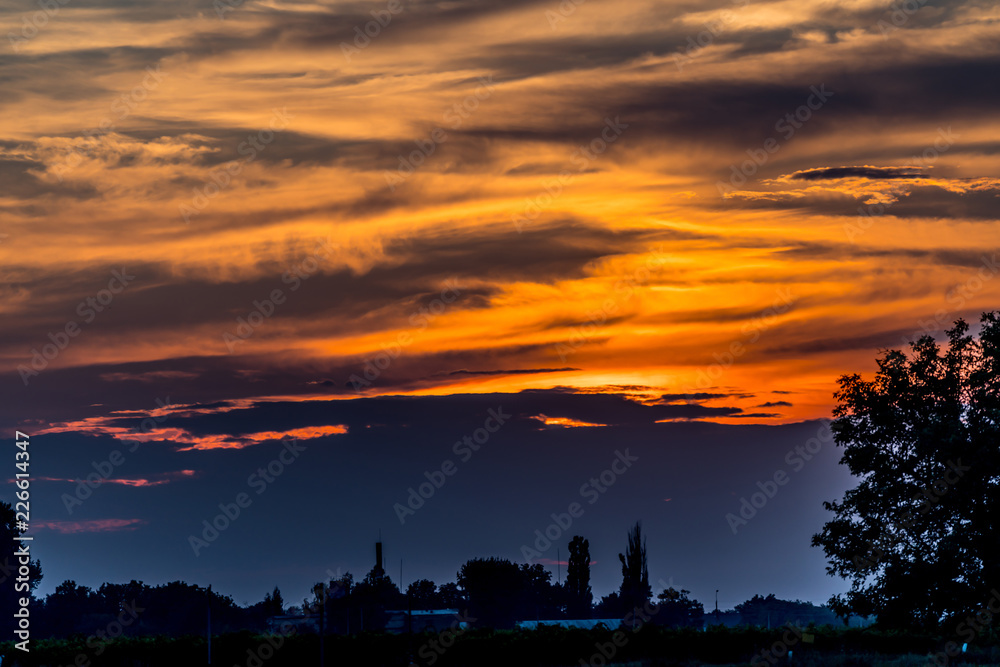 Silhouettes of the countryside at dusk, orange sunset. Silhouettes of the countryside at dusk, orange sunset.