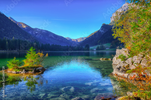 Fantastic autumn sunrise of Hintersee lake. Beautiful scene of trees on a rock island.