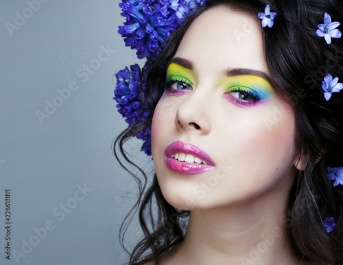 Beauty young woman with flowers and make up close up, real spring beauty girl photo