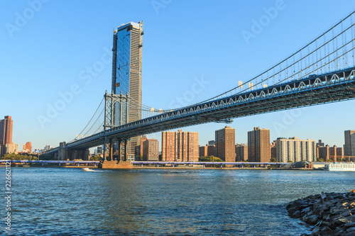 Manhattan Bridge over East River at the early morning sun light. The Bridge connects Lower Manhattan with Brooklyn of New York, USA.